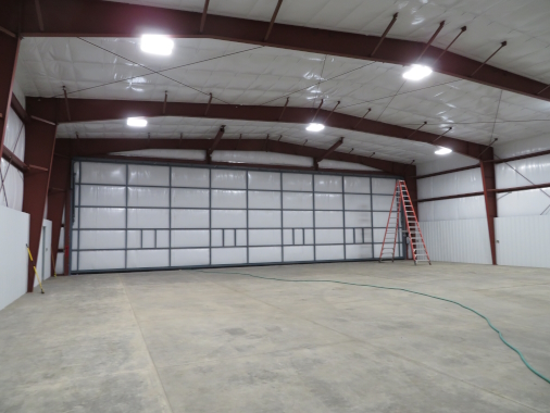 Single 70'x80' Nucor Hangar in Aurora, Oregon with high lift door