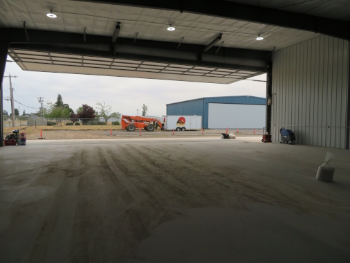 Nucor Hangar with grocery store columns to maximize width, with 18' high by 60' wide single leaf door